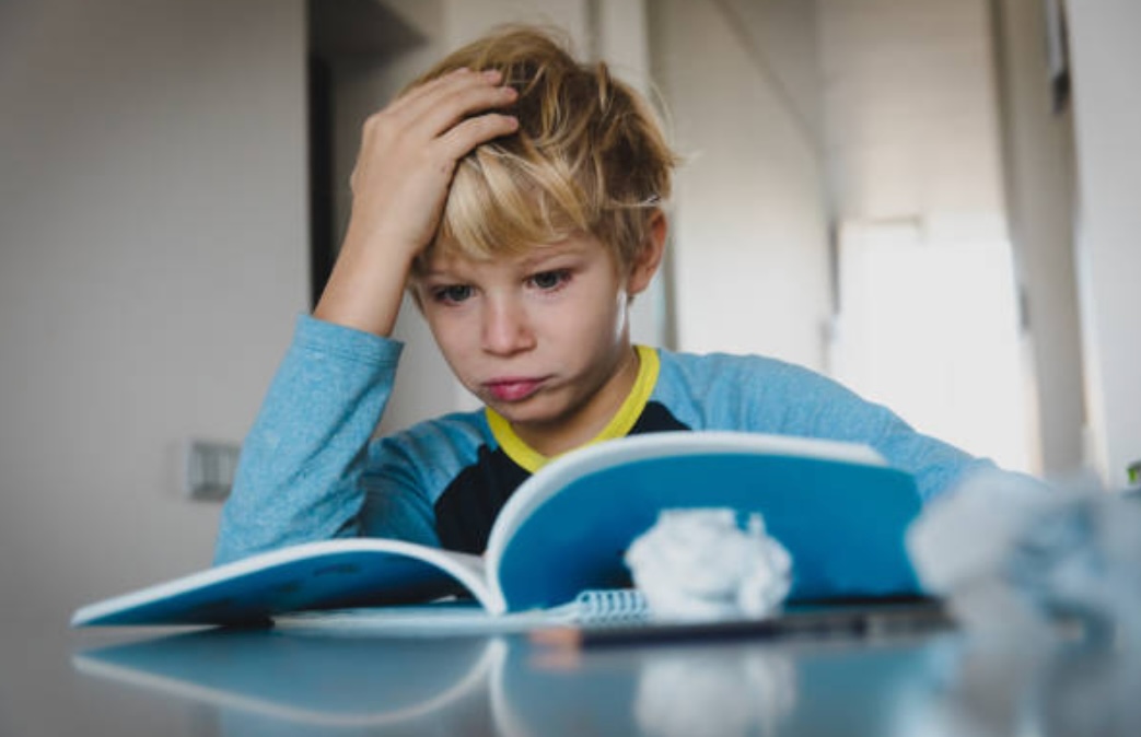 boy doing traditional homework instead of alternative homework ideas
