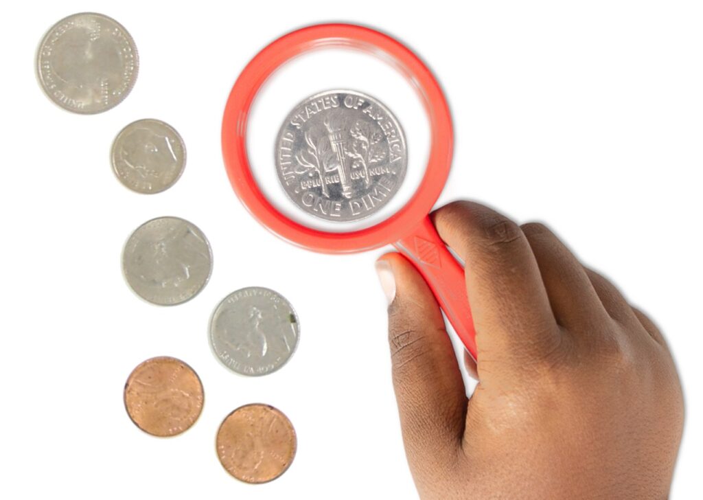 using a magnifying class to identify coins